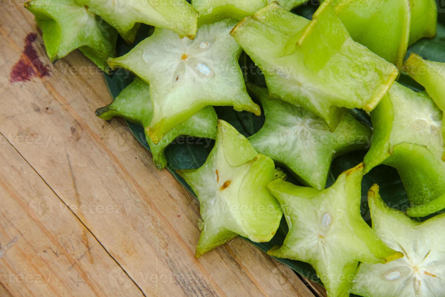 Carambola fruit with slice of star fruit on a wooden table photo