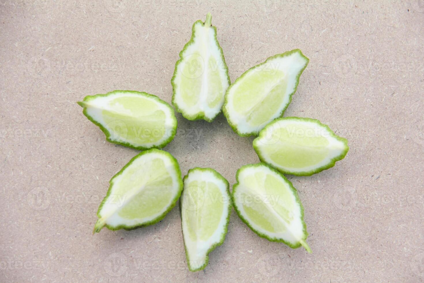 Fresh bergamot or sliced kaffir lime fruit with isolated on traditional wooden table photo