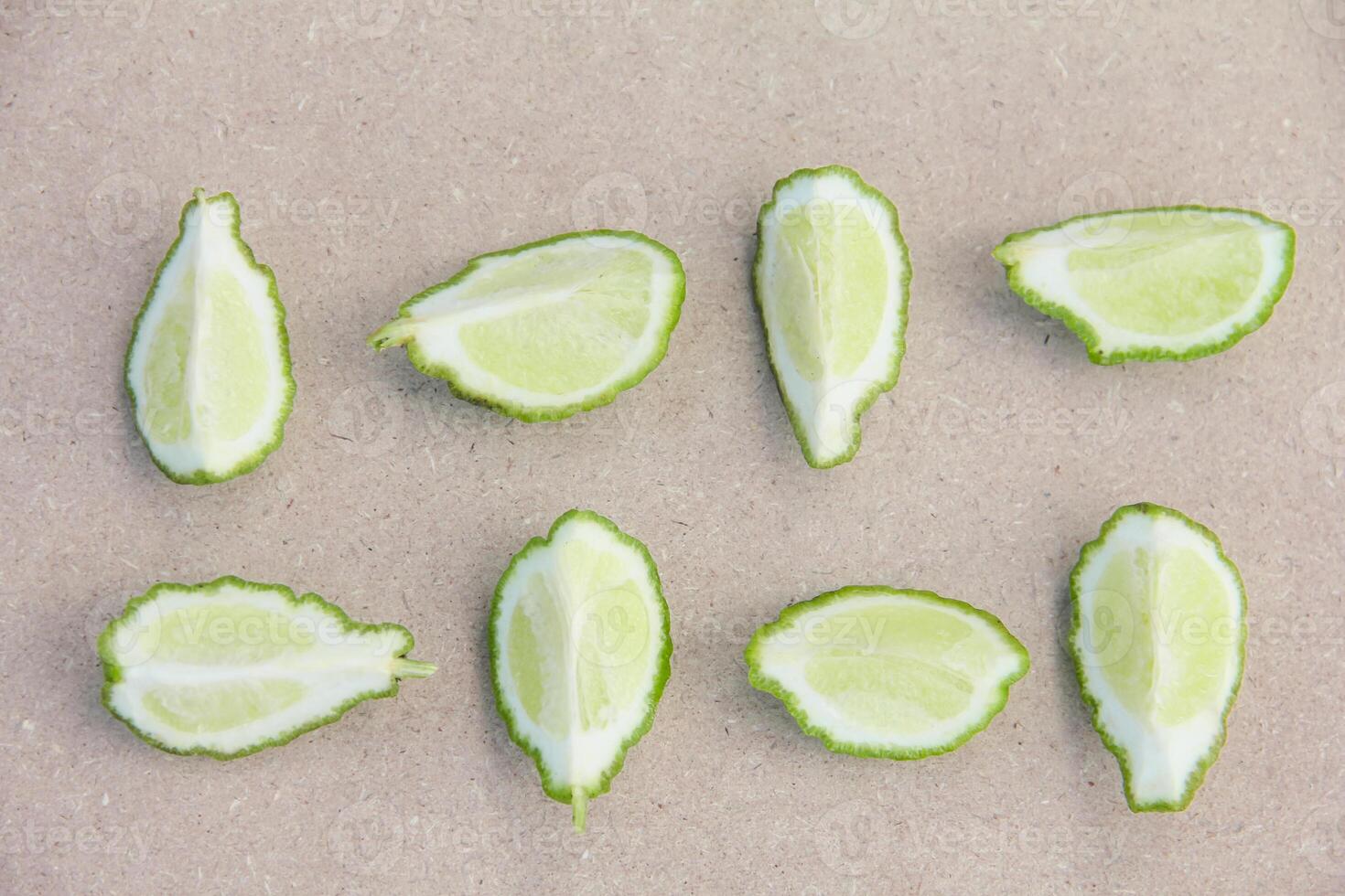 Fresh bergamot or sliced kaffir lime fruit with isolated on traditional wooden table photo