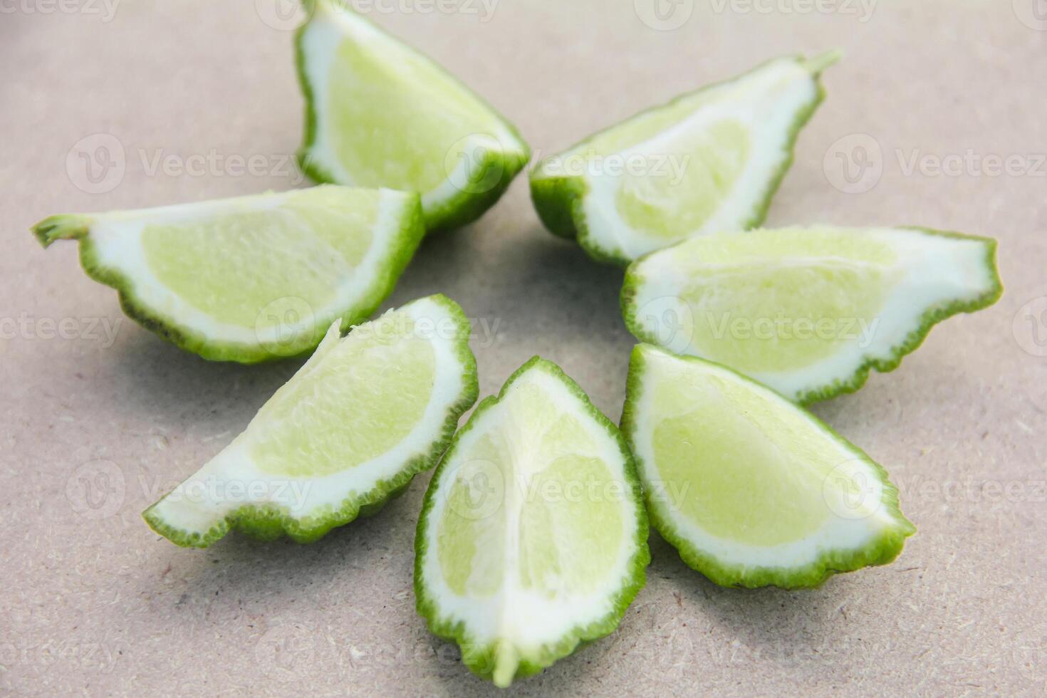 Fresh bergamot or sliced kaffir lime fruit with isolated on traditional wooden table photo