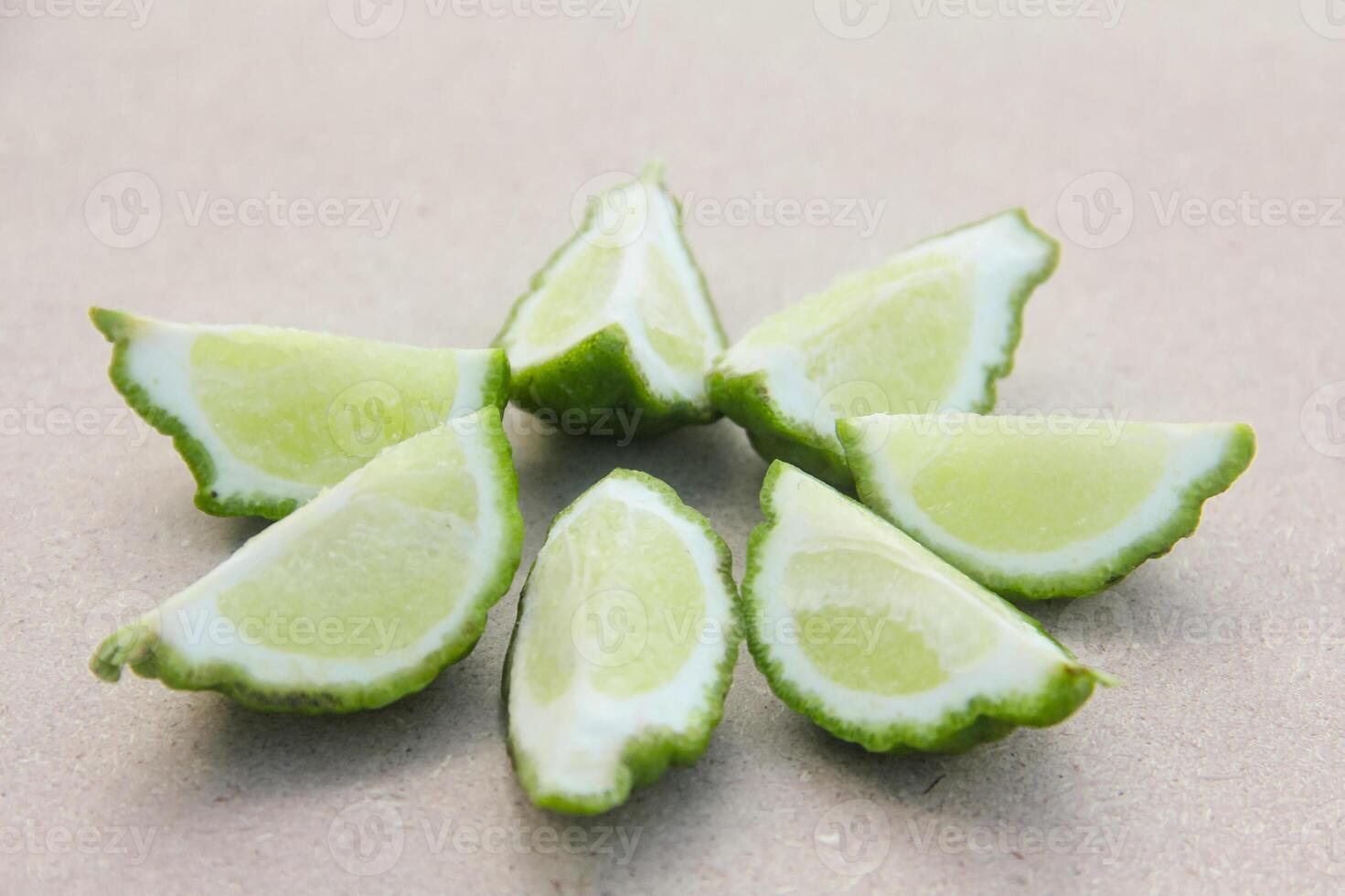 Fresh bergamot or sliced kaffir lime fruit with isolated on traditional wooden table photo