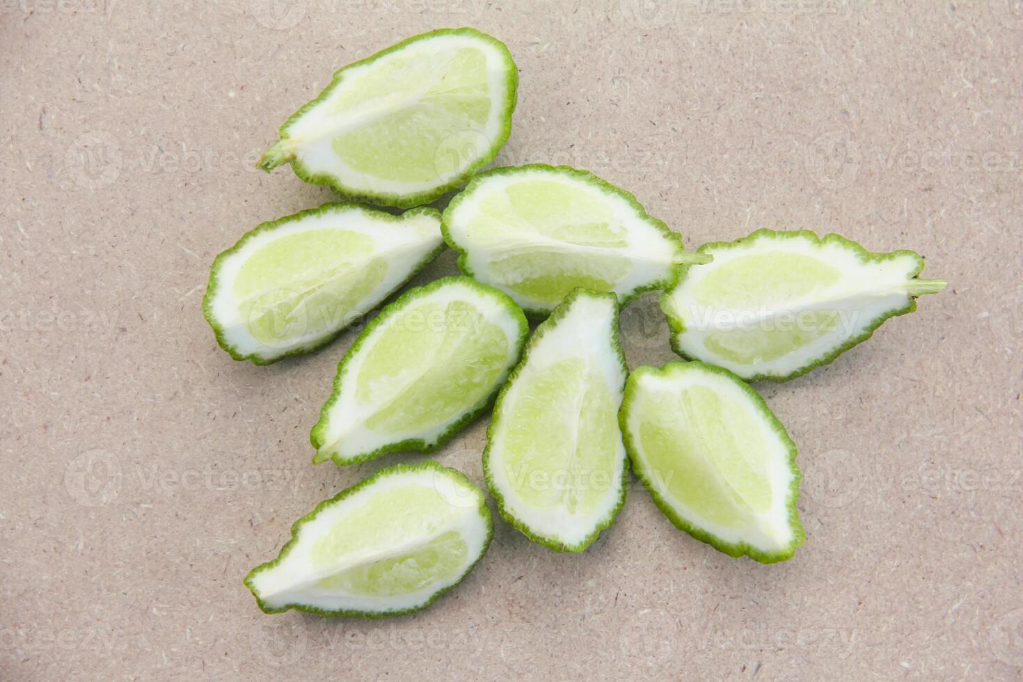 Fresh bergamot or sliced kaffir lime fruit with isolated on traditional wooden table photo