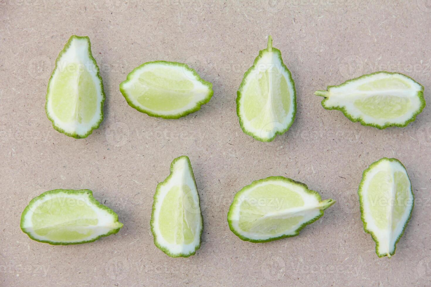 Fresh bergamot or sliced kaffir lime fruit with isolated on traditional wooden table photo