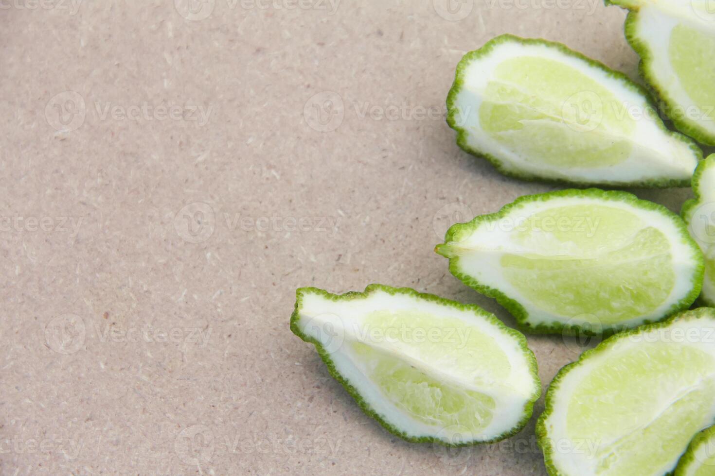 Fresh bergamot or sliced kaffir lime fruit with isolated on traditional wooden table photo