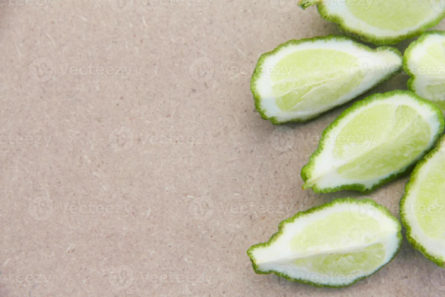Fresh bergamot or sliced kaffir lime fruit with isolated on traditional wooden table photo