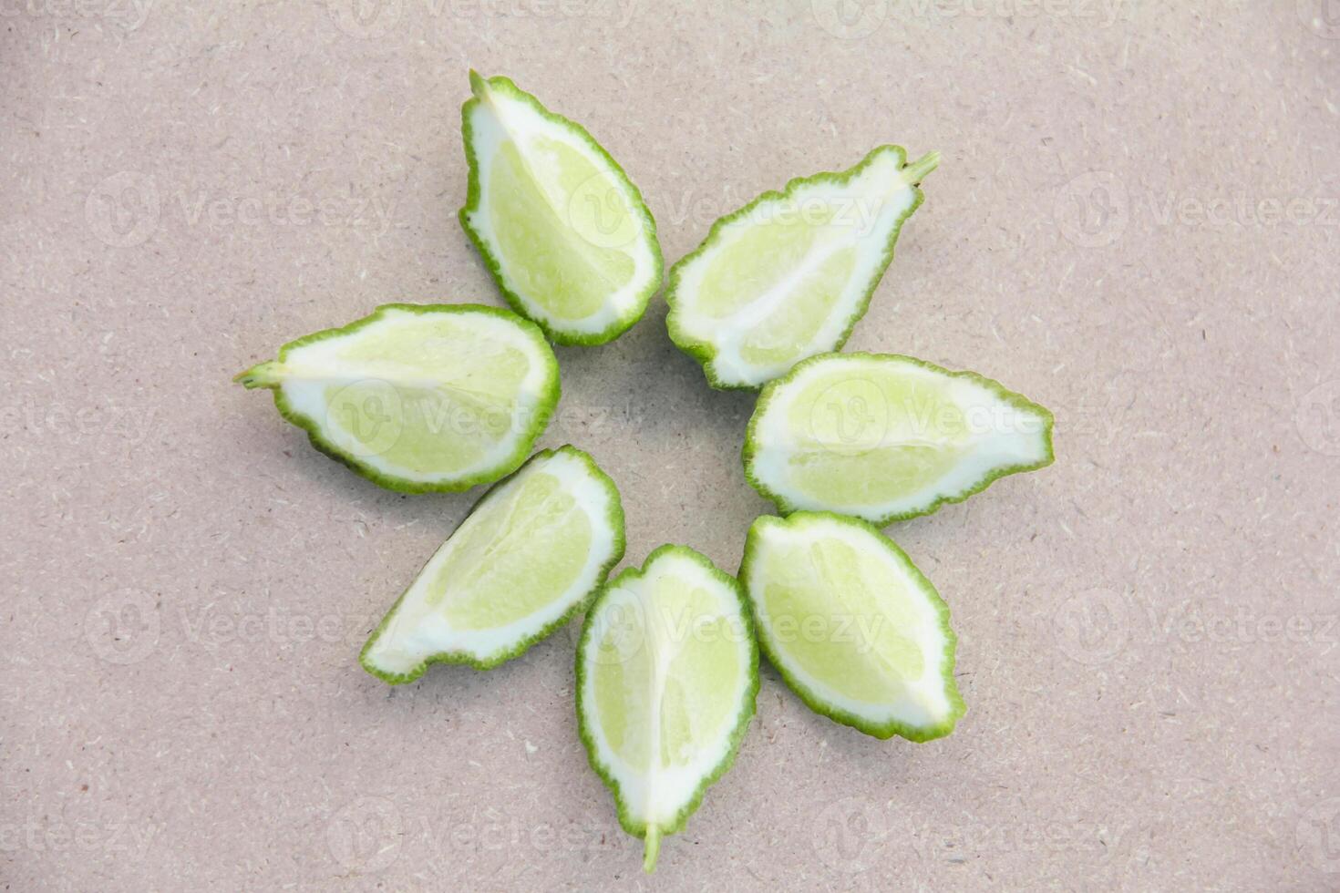 Fresh bergamot or sliced kaffir lime fruit with isolated on traditional wooden table photo