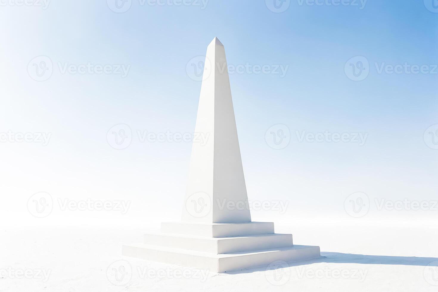 Minimalist White Obelisk Under Blue Sky photo