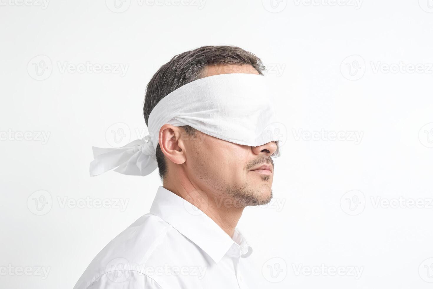 Blindfolded Man in White Shirt photo