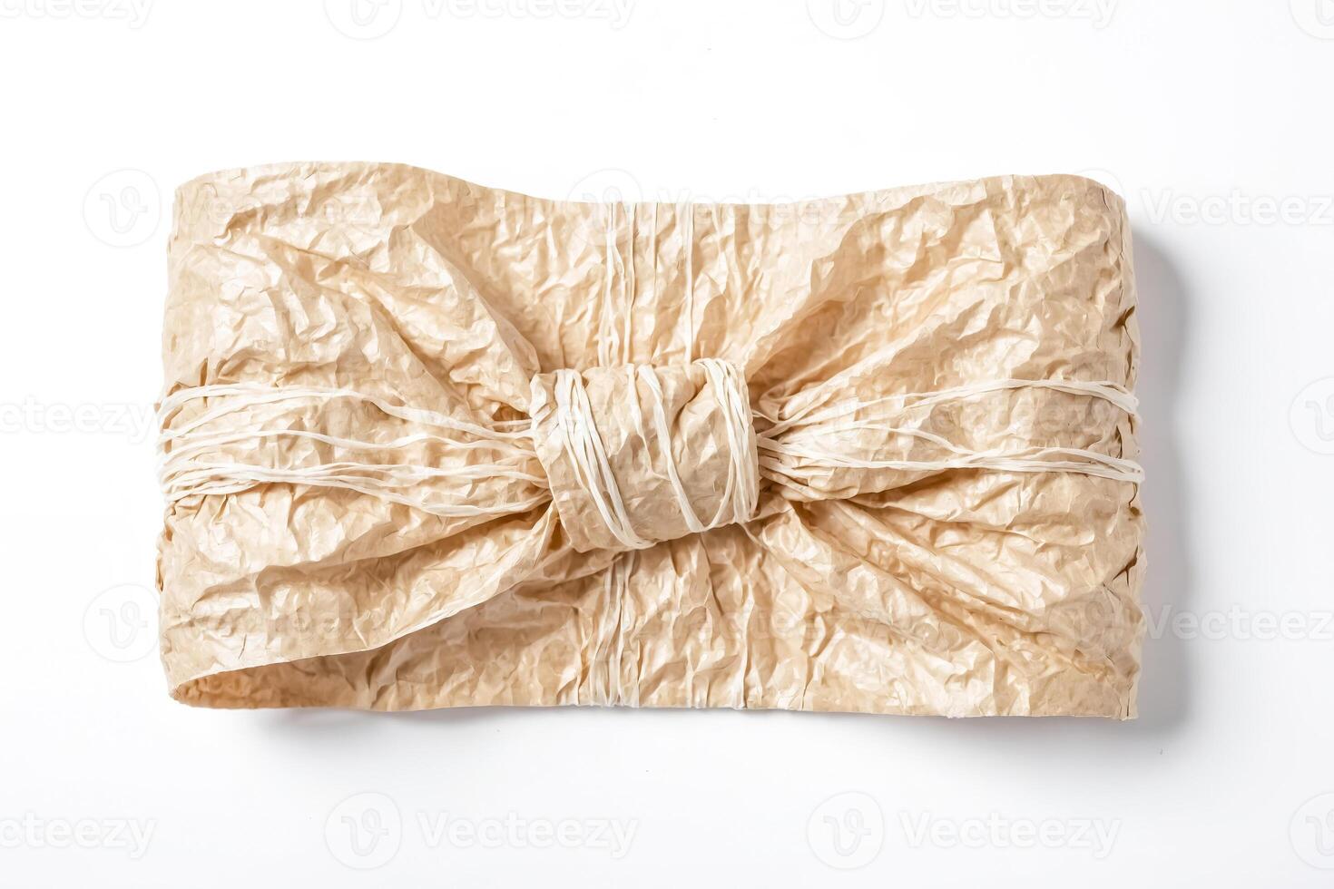Crumpled Brown Paper Bag With White String Bow photo