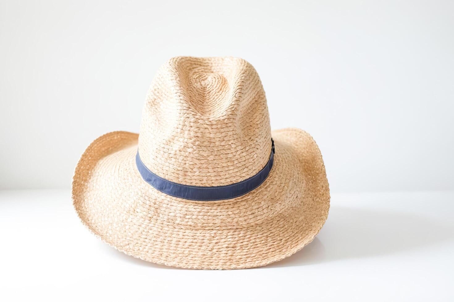 Straw Hat with Blue Band on White Background photo