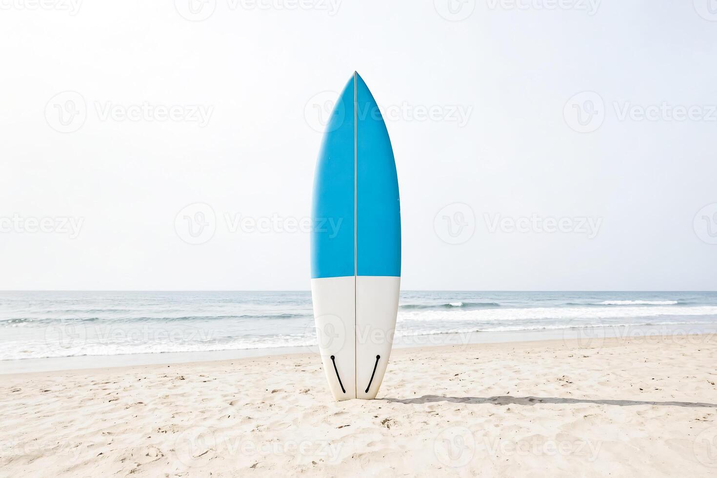 Surfboard on a sandy beach photo