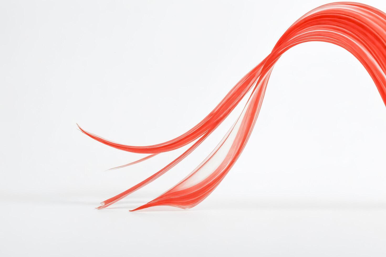Abstract Red Flowing Fabric on White Background photo