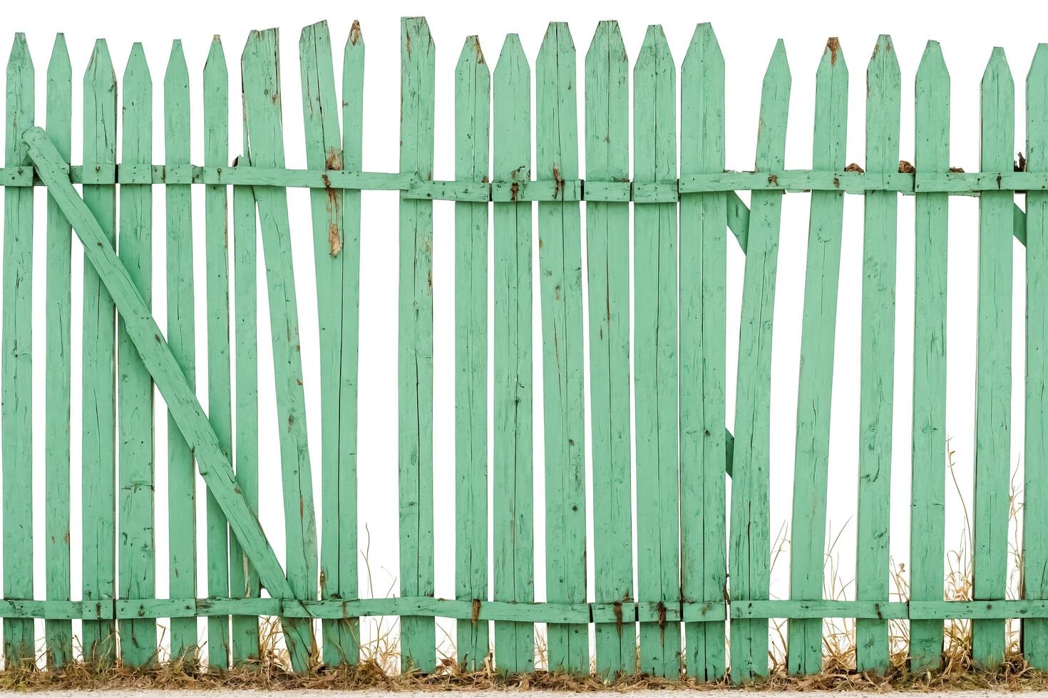 Old green wooden fence with broken boards photo