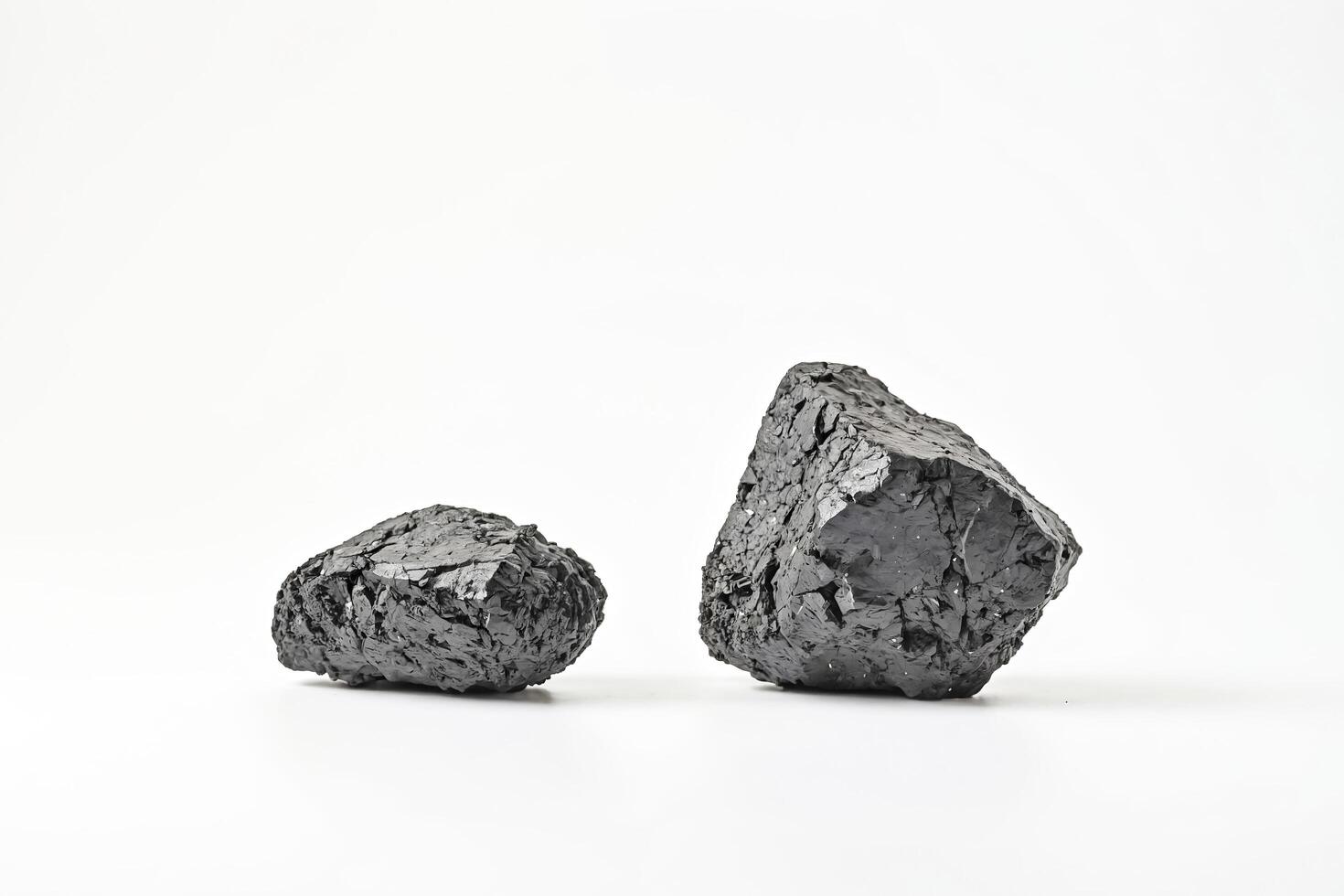Two Pieces of Coal on a White Background photo