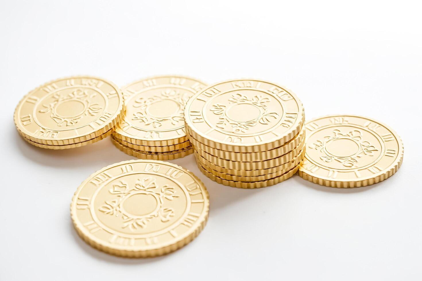 Golden Coins Stacked on White Background photo