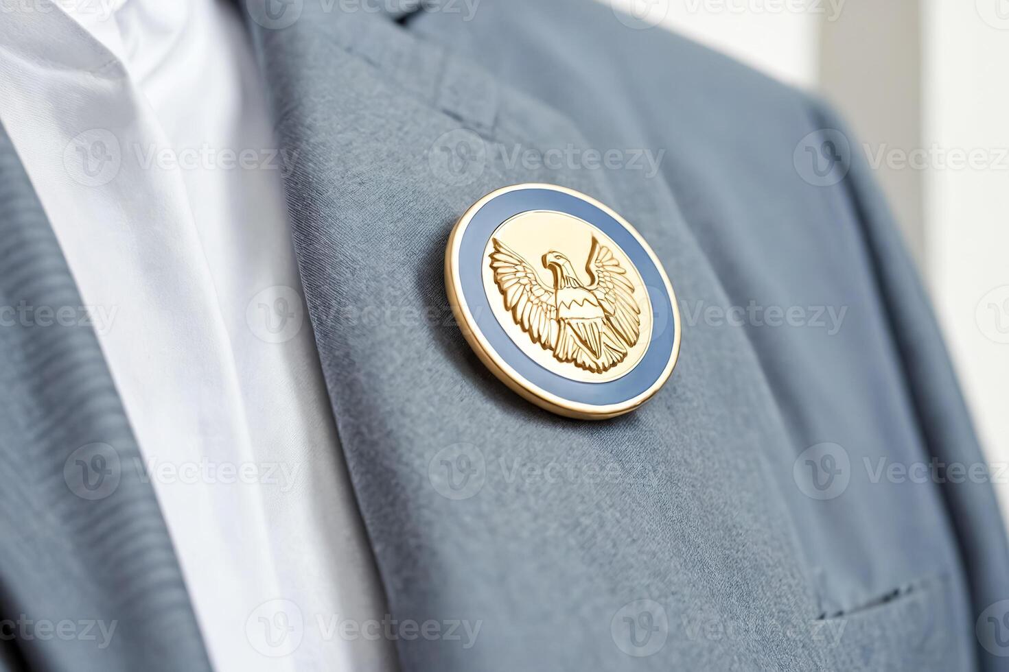 Close up of a golden eagle pin on a blue suit photo