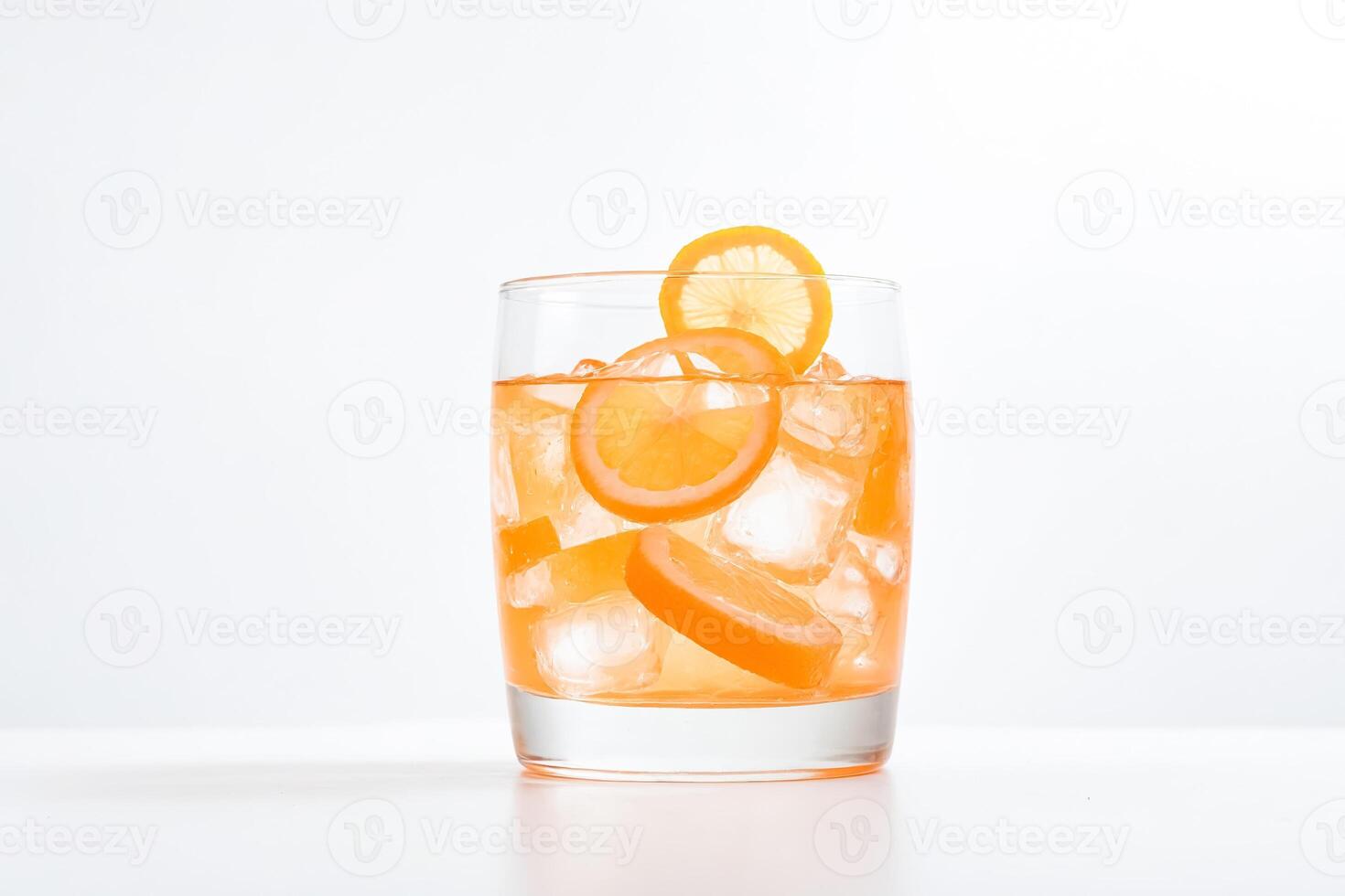 Glass of Orange Juice with Ice and Lemon Slices photo