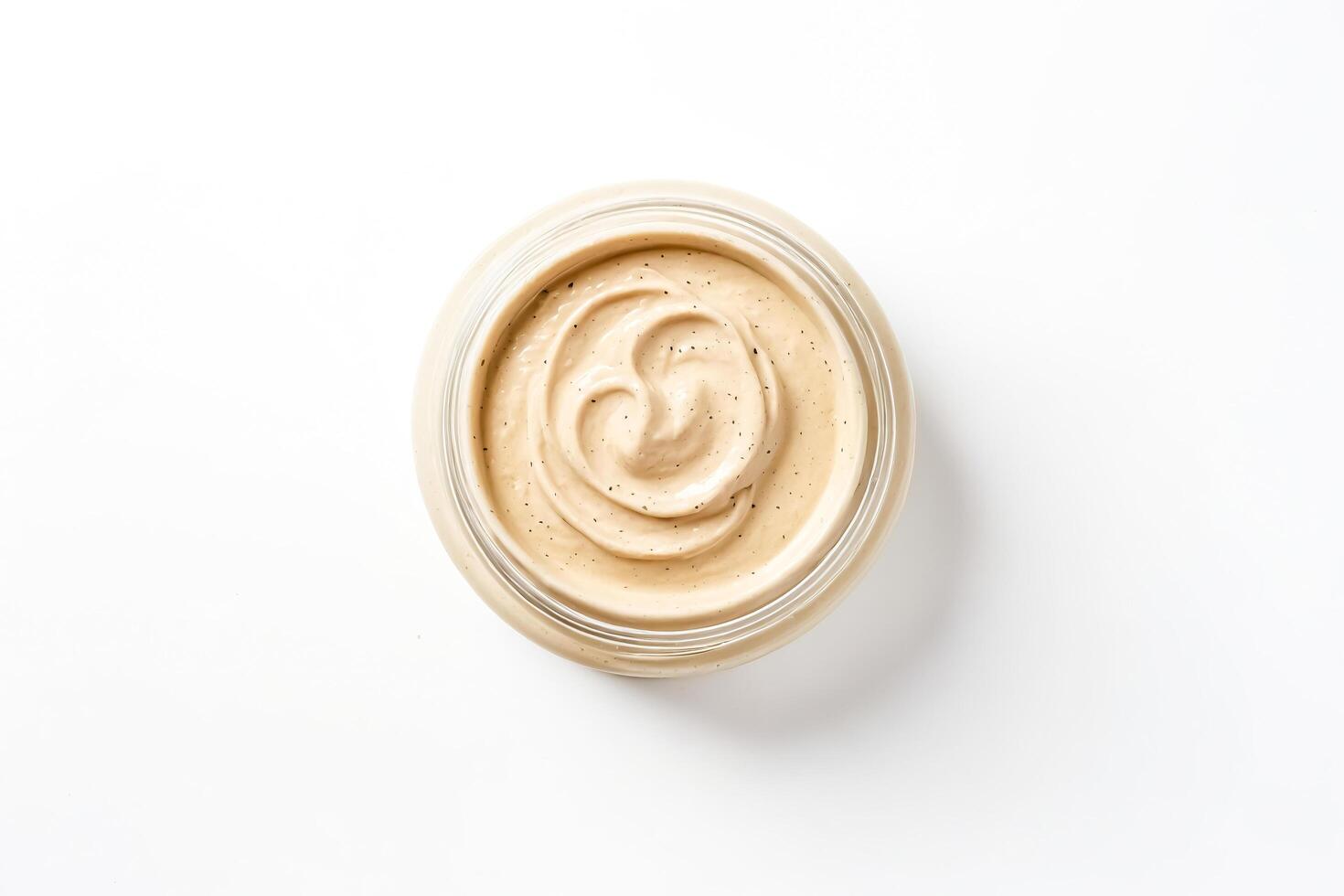 Close Up of Beige Cream in Glass Jar photo