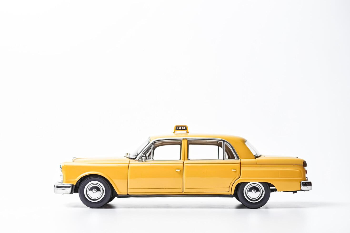 Yellow Taxi Cab Toy on White Background photo