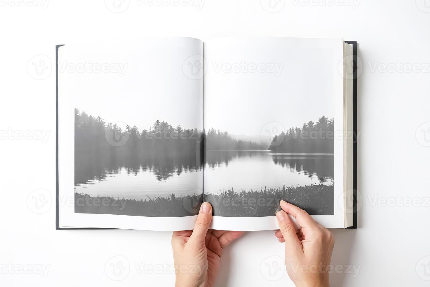 Hands Holding Open Book with Forest and Lake Photo