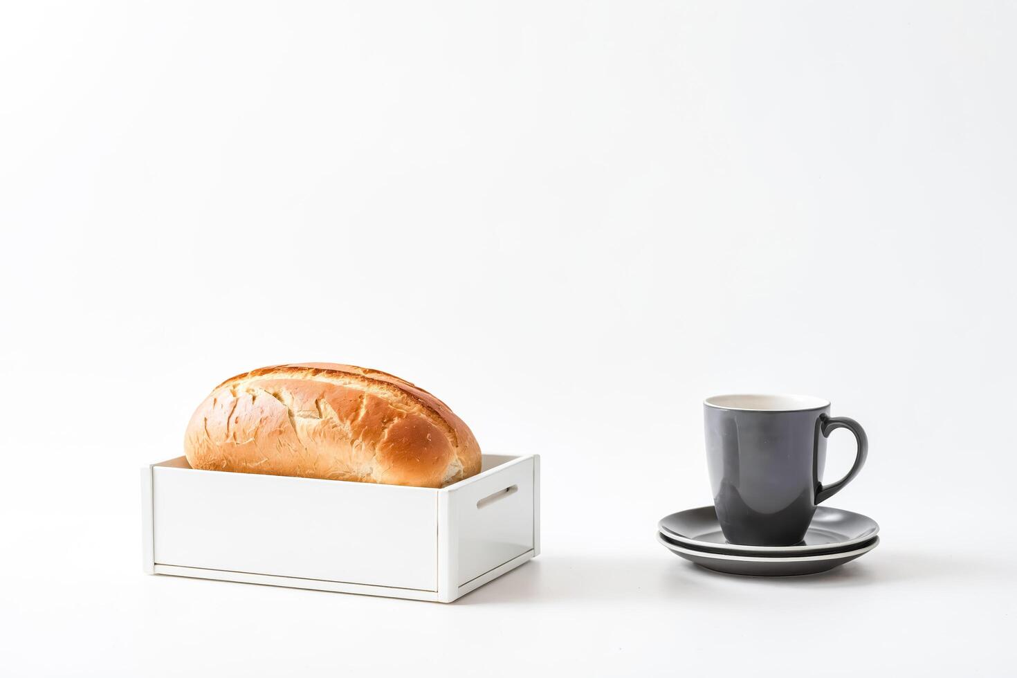 White Bread Loaf In A Box With A Coffee Cup And Saucer photo