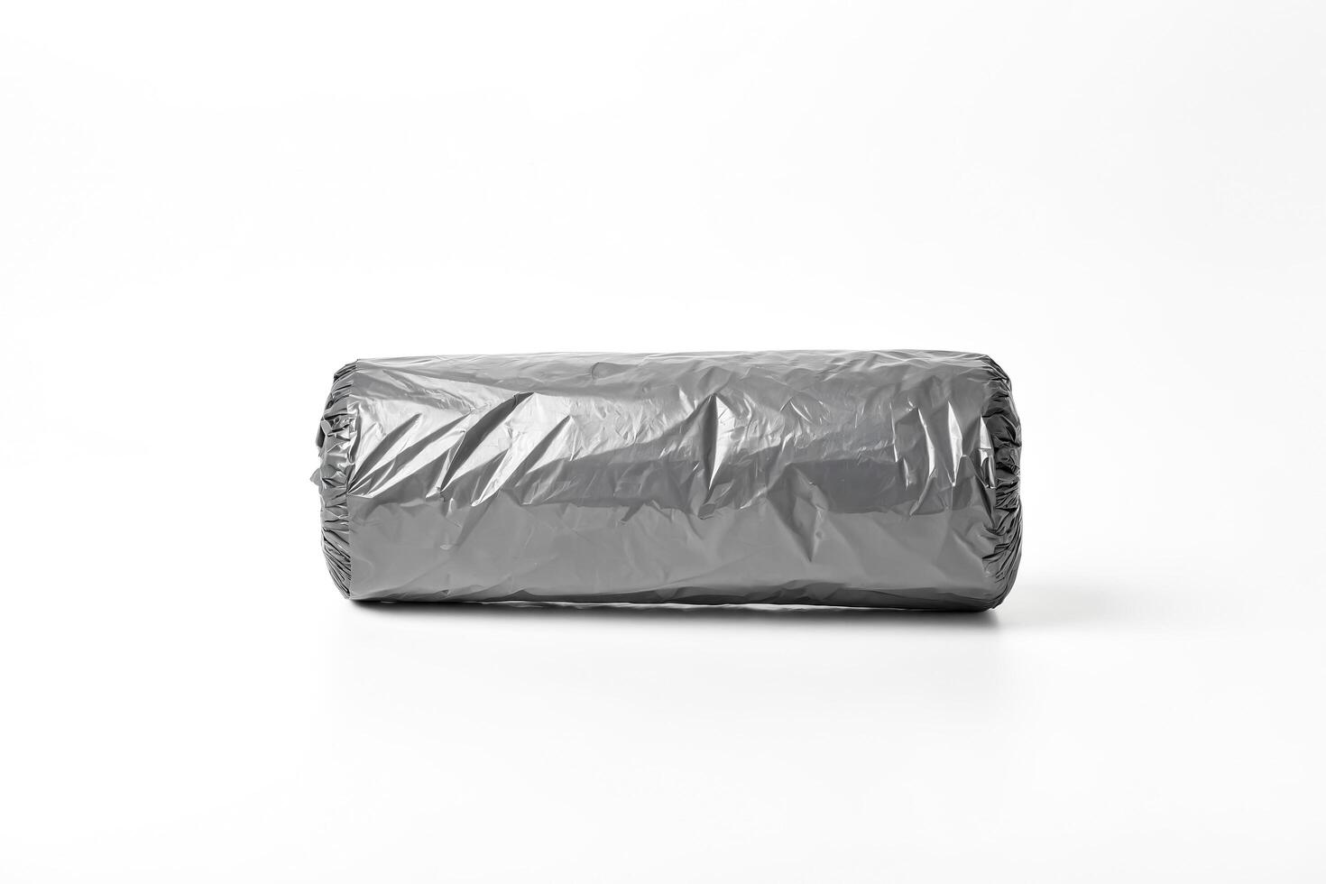 Rolled Up Black Plastic Bag On White Background photo