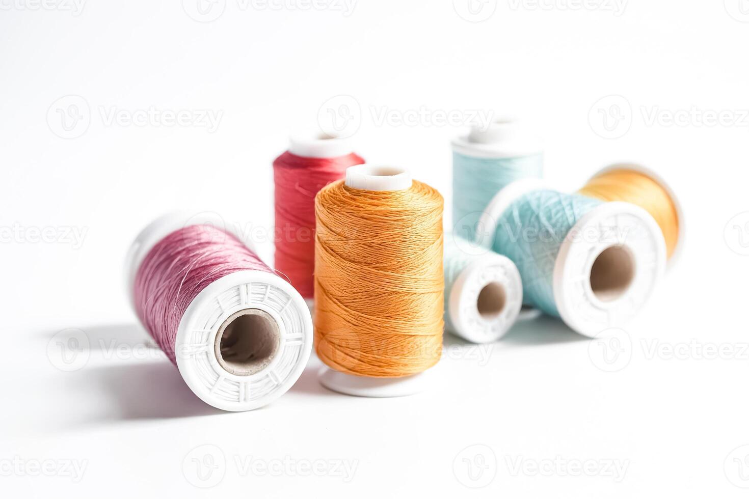Colorful spools of thread on a white background photo