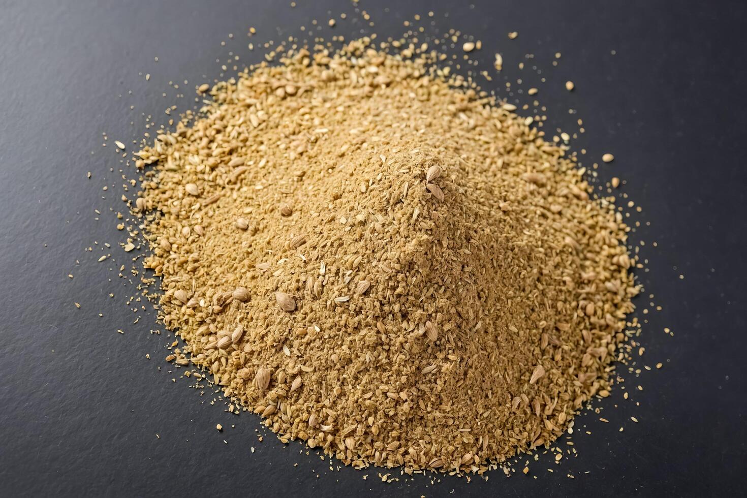 Heap of Dried Coriander Seeds on a Black Background photo