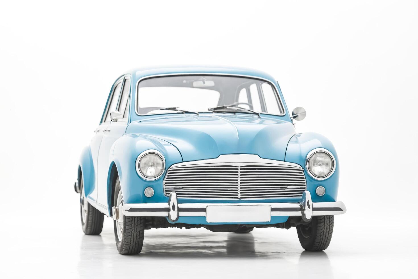 An old vintage car in blue color on a white background. photo