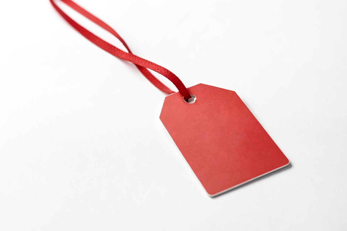 Red Tag with Ribbon on White Background photo