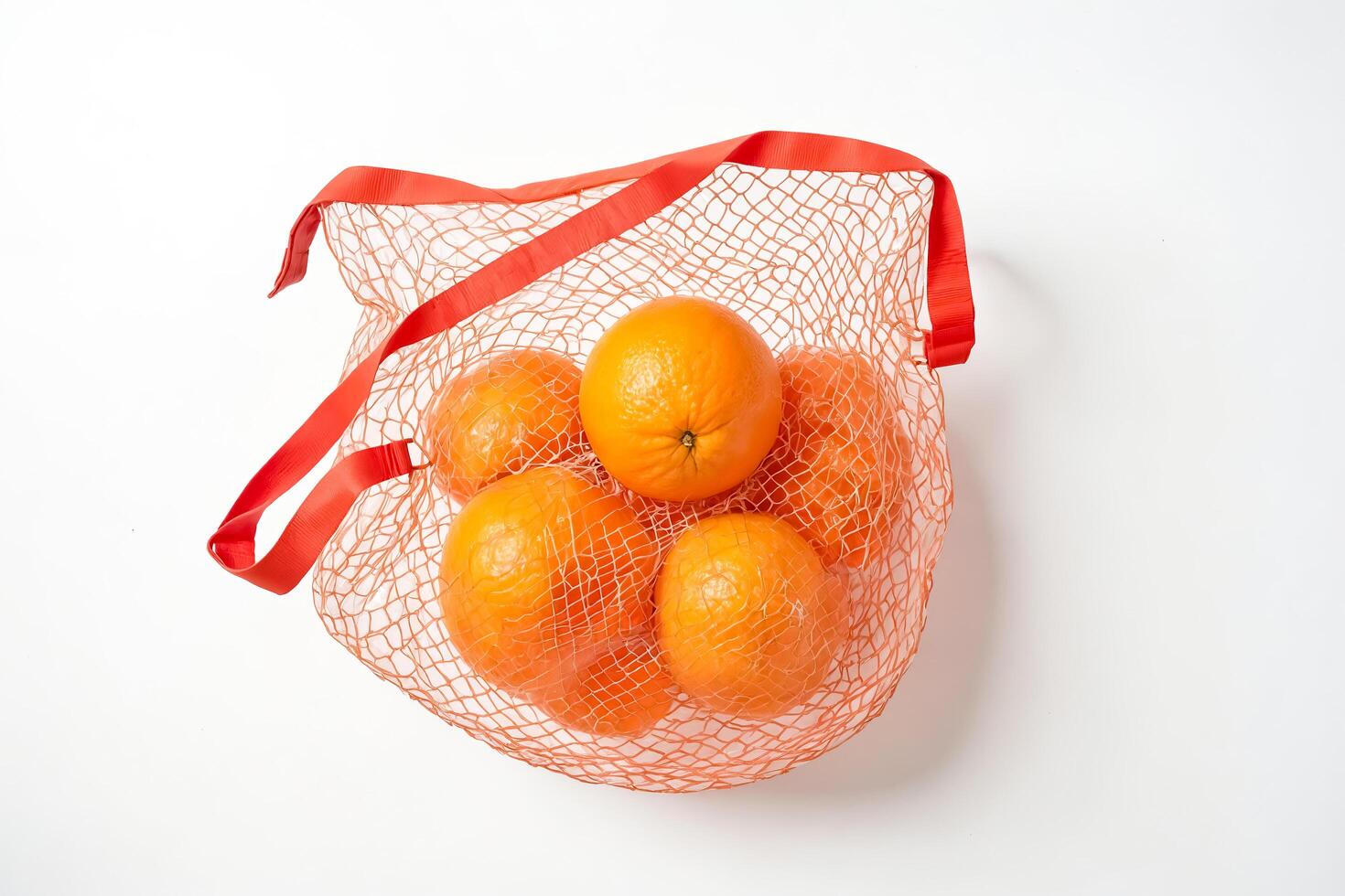 Oranges in a Red Mesh Bag photo