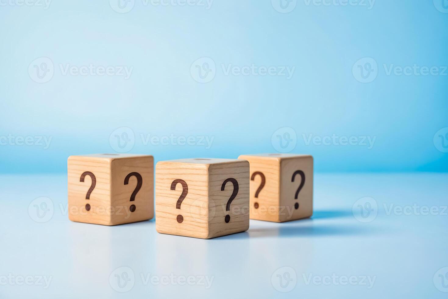 Wooden blocks with question marks on a blue background photo