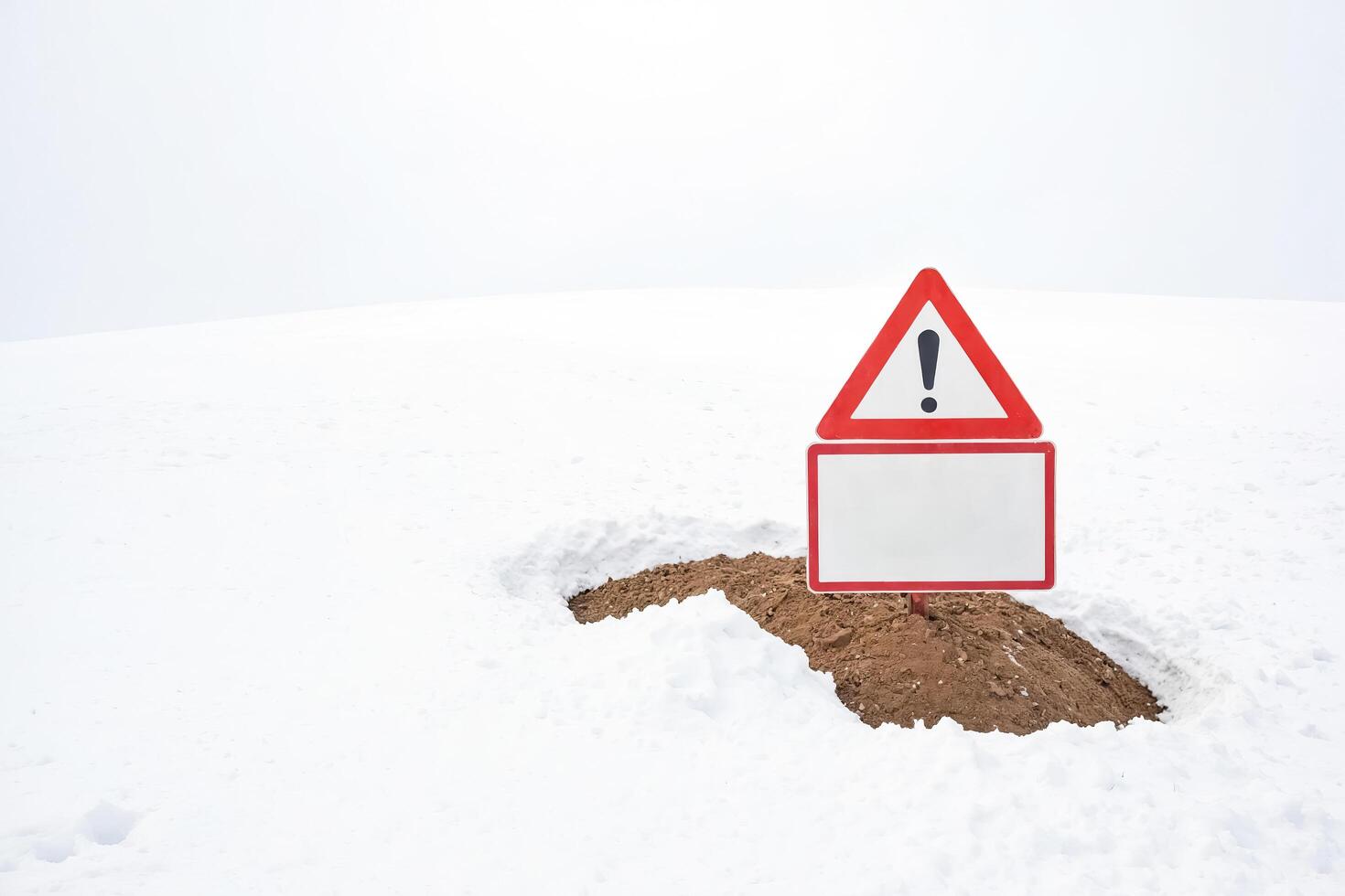 Warning Sign in a Snowy Field photo