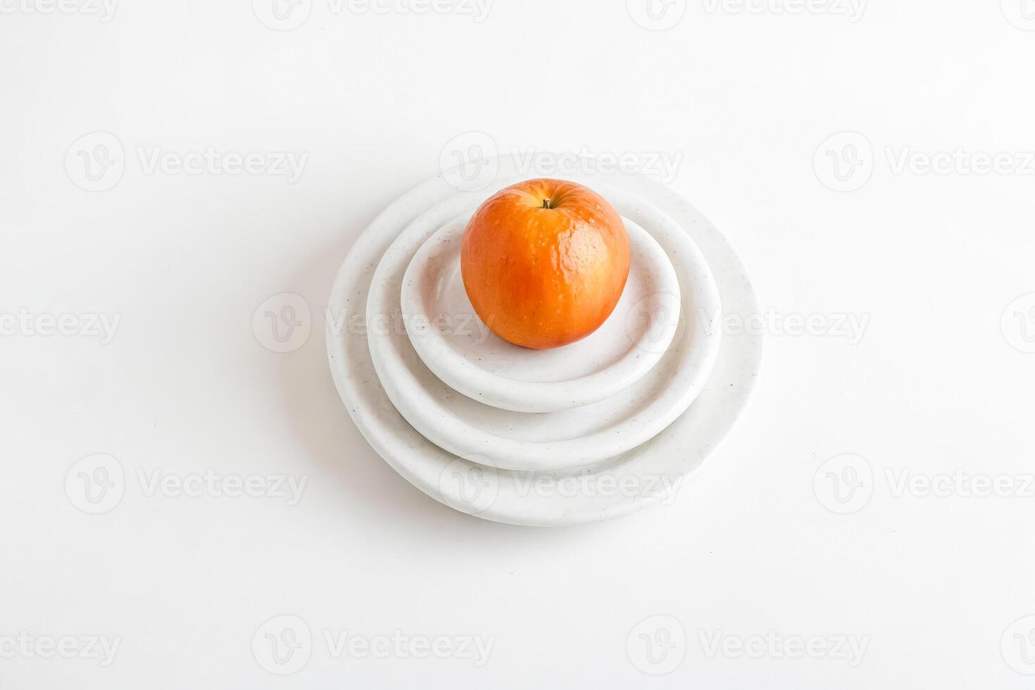Single apple on white plate photo