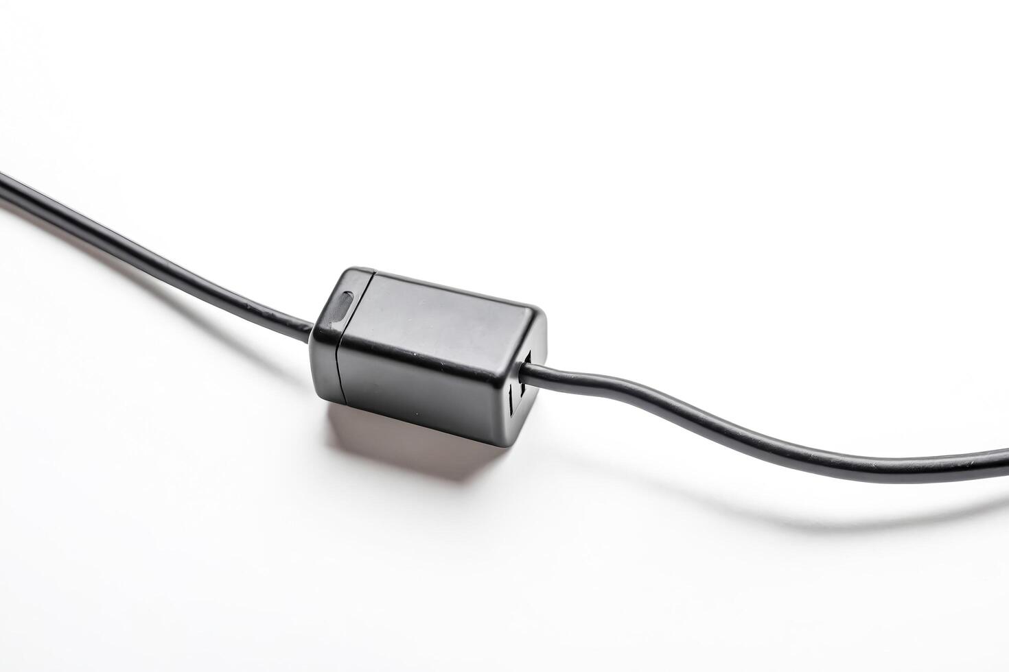 Black power cord with plug isolated on white background photo