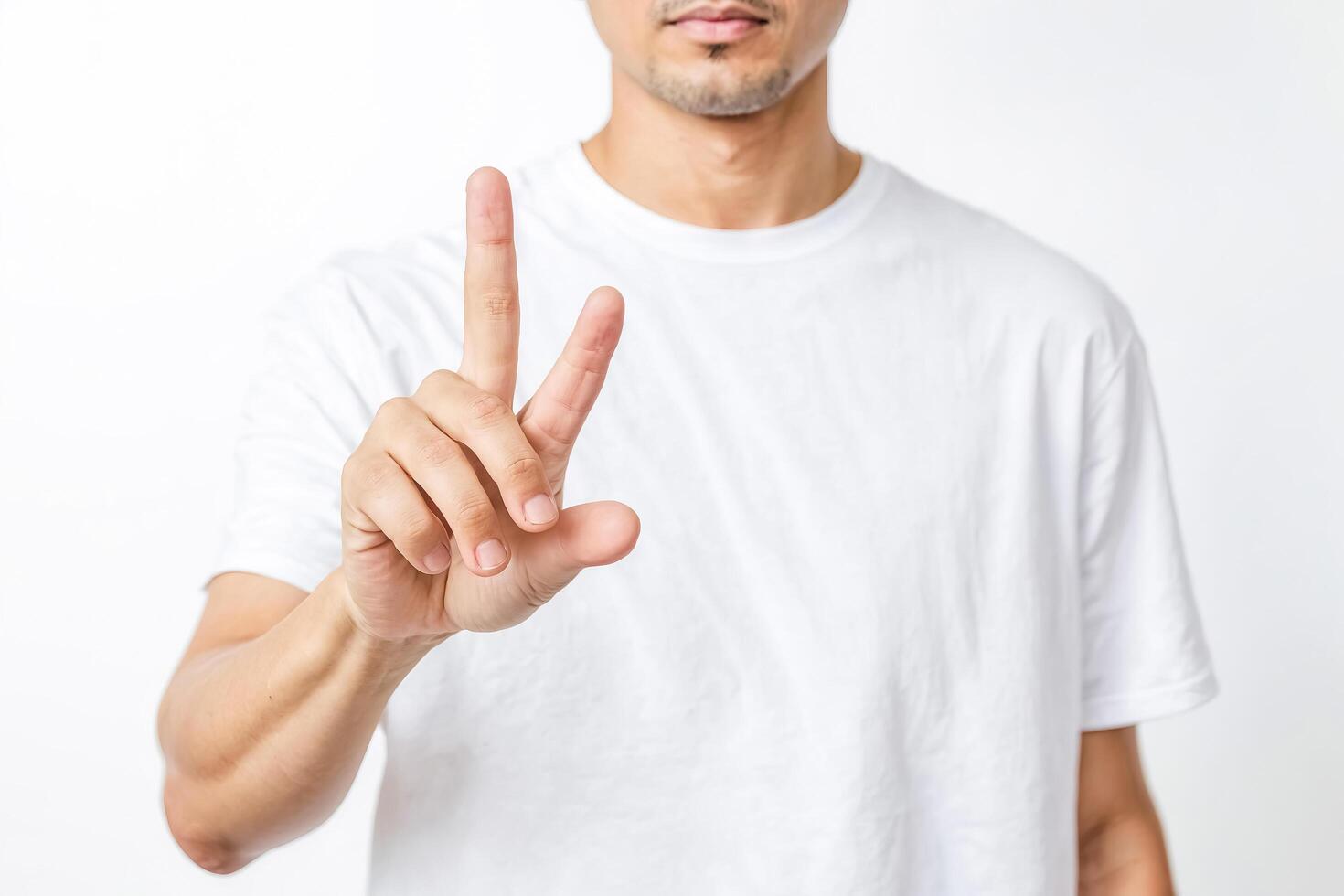 Man pointing with finger against white background photo