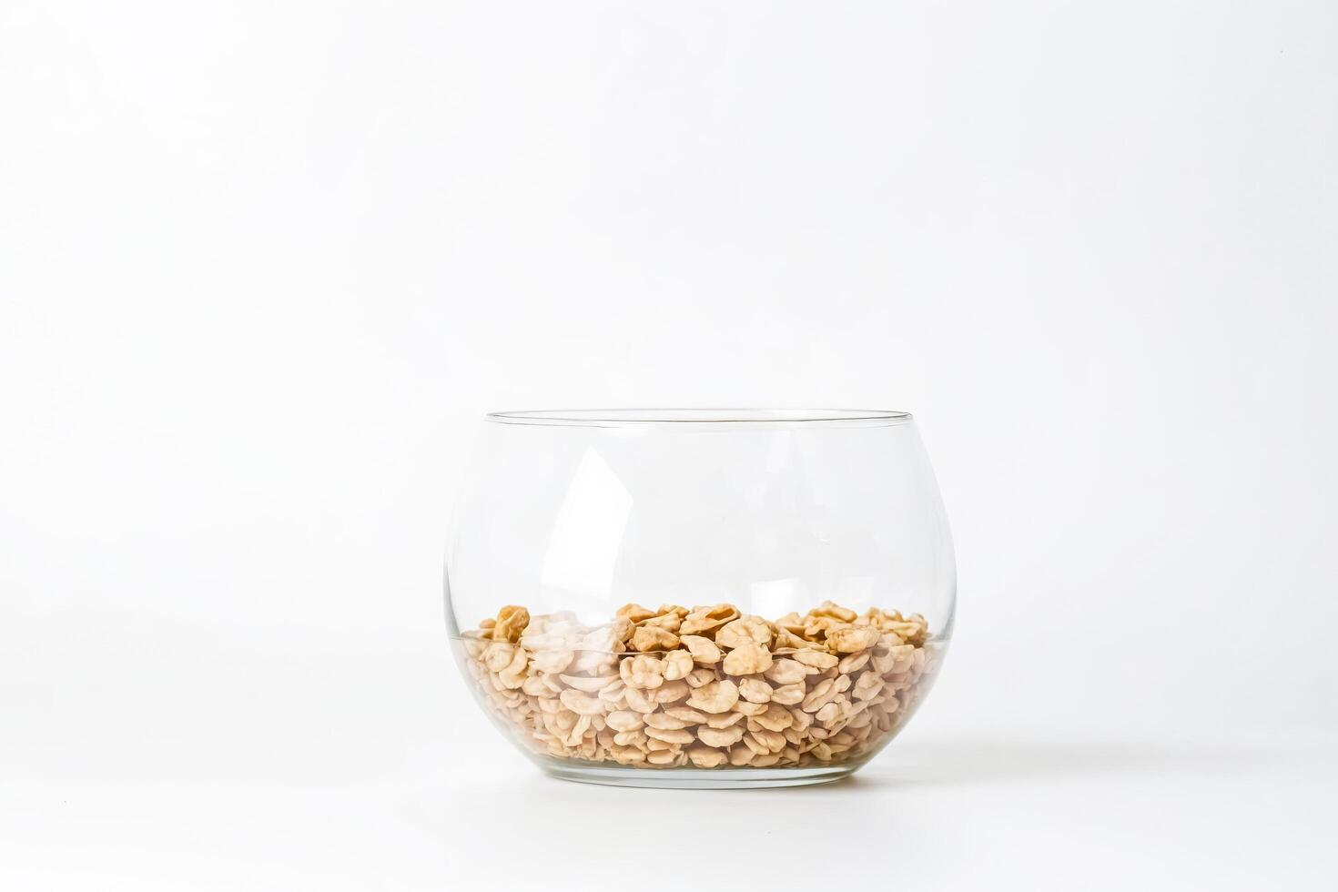 Glass Bowl with Cereal on White Background photo