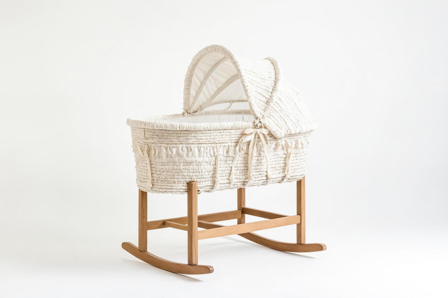 White wicker Moses basket with wooden stand isolated on white background photo