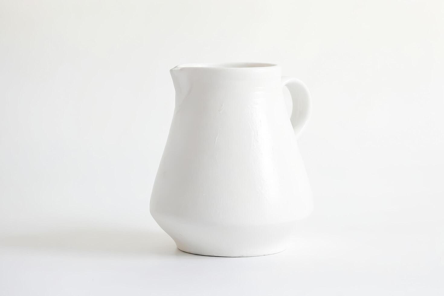 White Ceramic Pitcher on White Background photo
