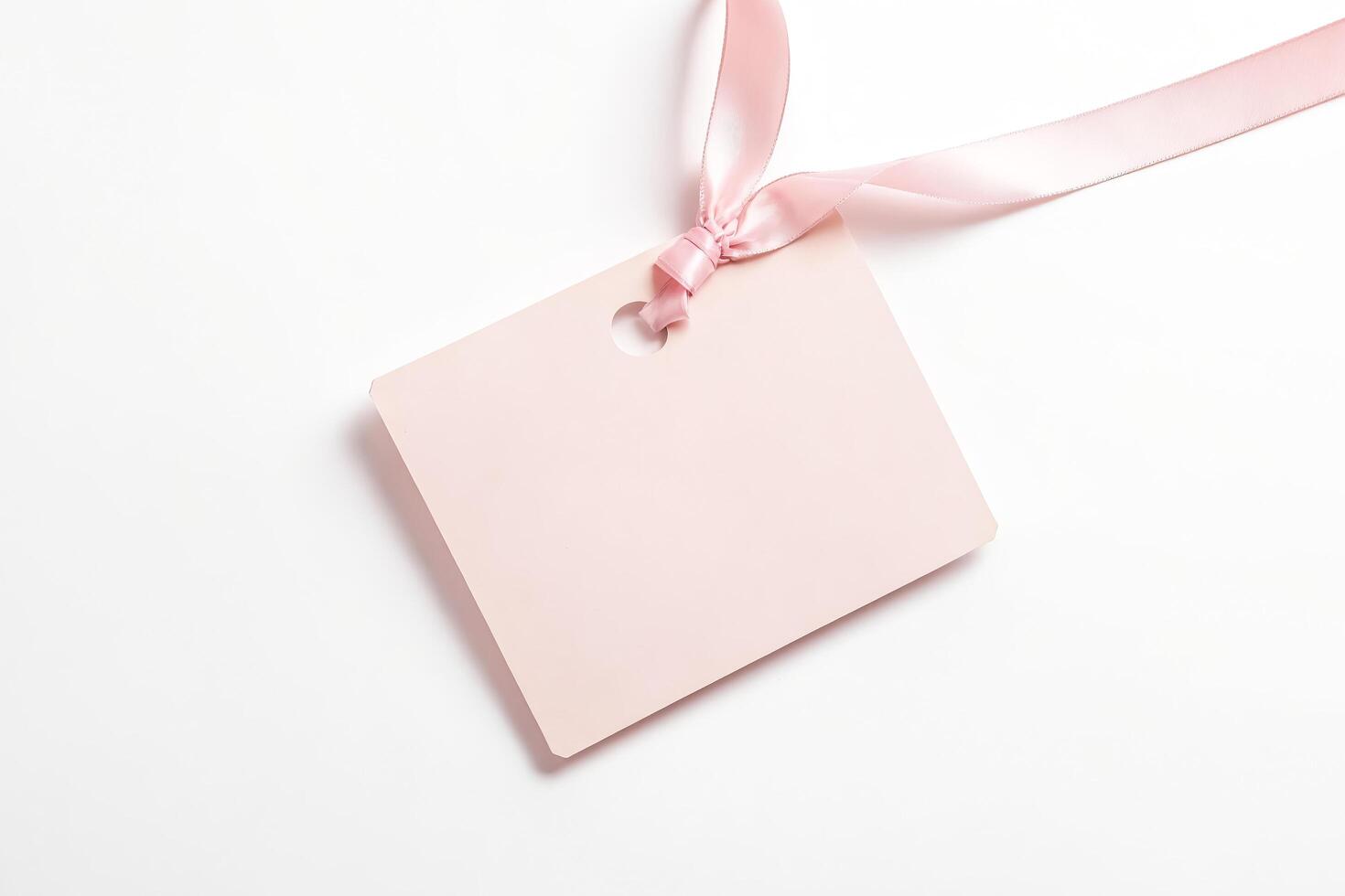 Pink ribbon tied around a tag photo