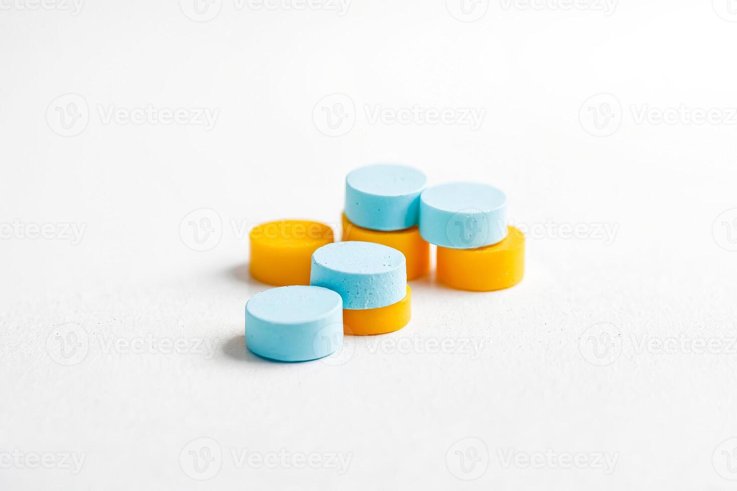 Stack of Blue and Yellow Round Objects on White Background photo