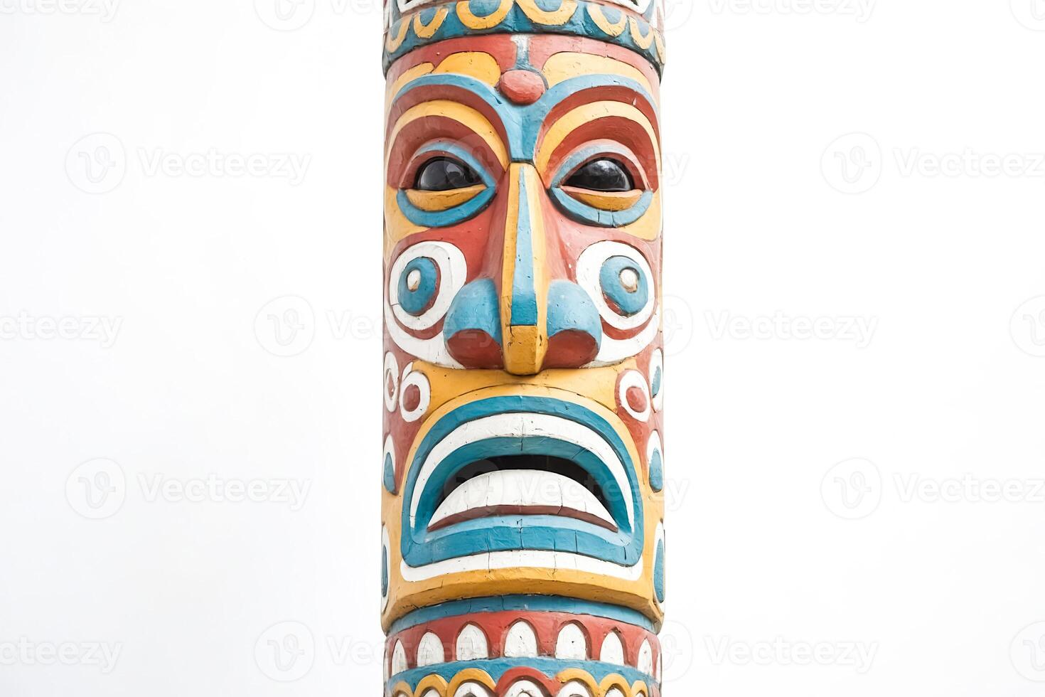 Close-up of a Colorful Totem Pole with a Face Carving photo
