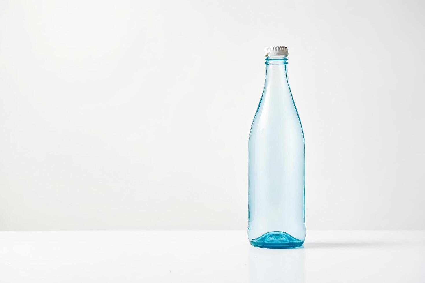 Blue Glass Bottle with White Cap on a White Background photo