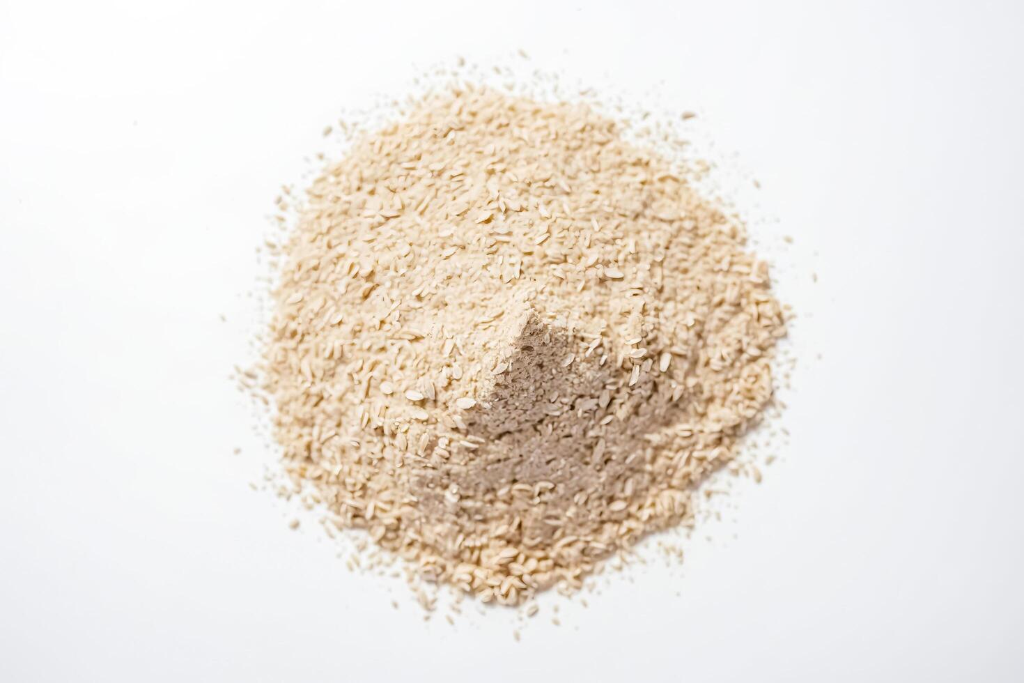 Close-up of a Heap of Rolled Oats on a White Surface photo