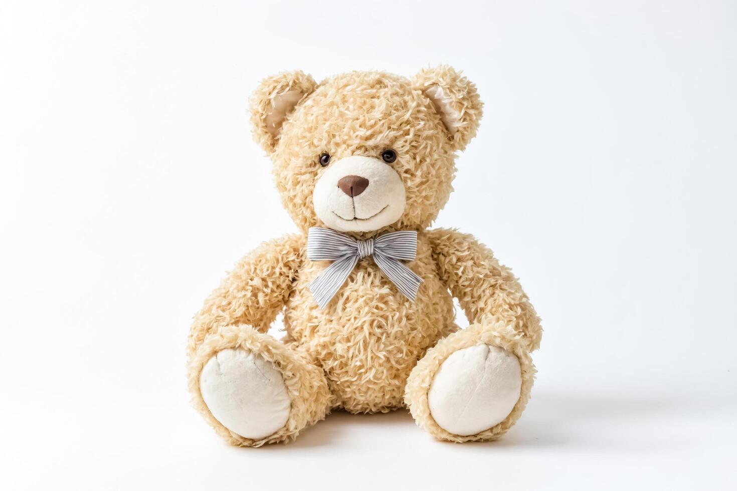 Plush Teddy Bear with Blue Bow Isolated on White Background photo