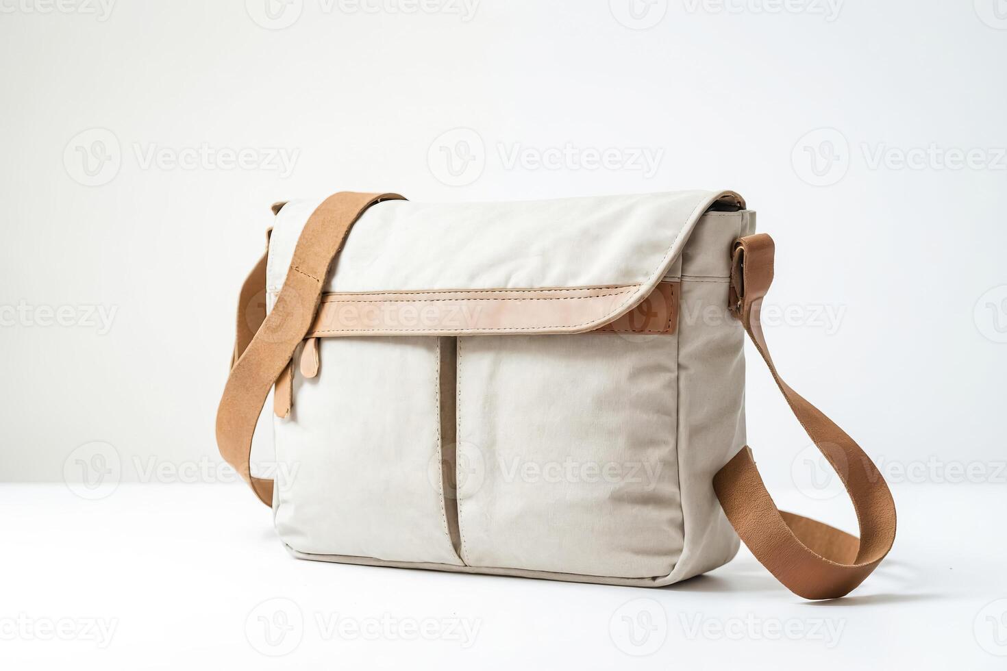 Beige canvas shoulder bag with brown leather straps photo