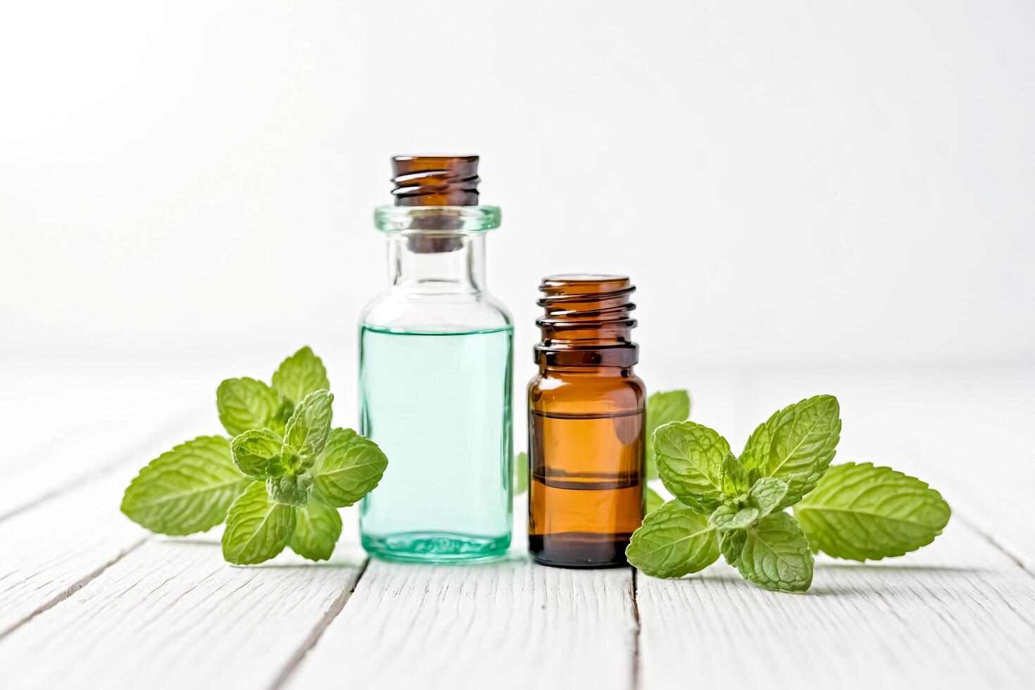 Peppermint Essential Oil Bottles With Fresh Mint Leaves on White Wooden Background photo
