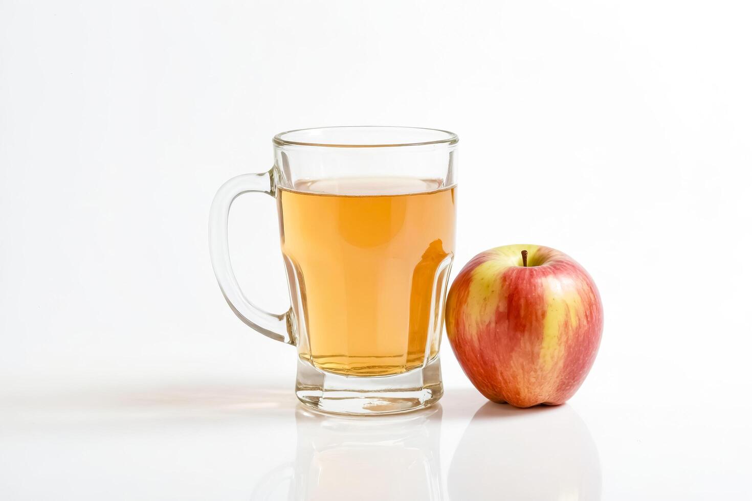 Glass of apple juice with an apple on a white background photo