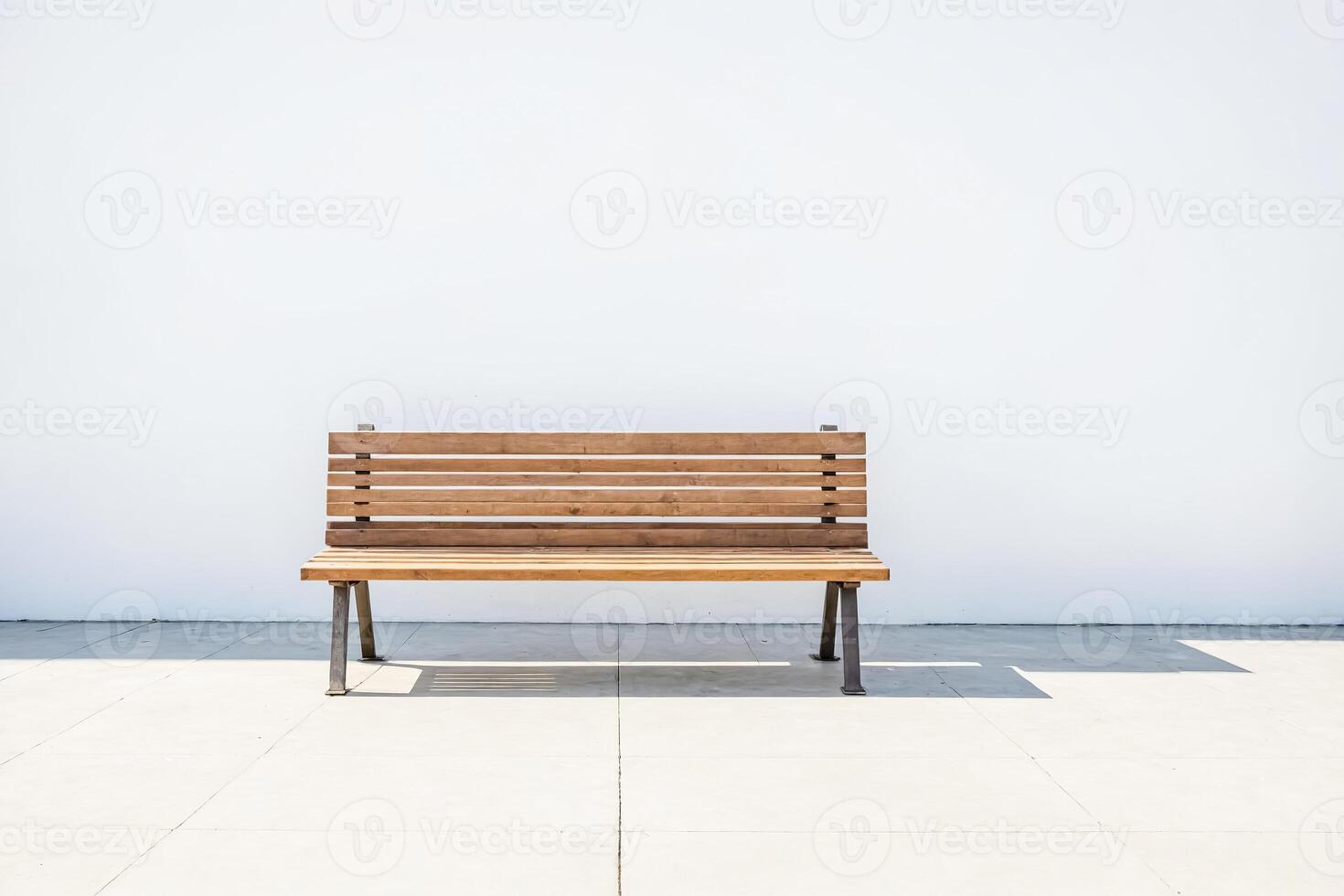 Empty Wooden Bench in Front of White Wall photo