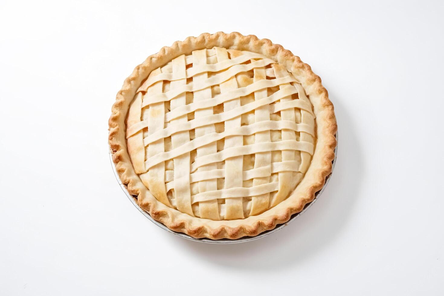 Homemade apple pie with a lattice crust on a white background photo